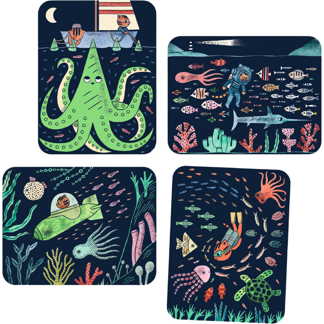 Vier ingekleurde kaarten van de magic reveal paint set met levendige onderwater scènes.