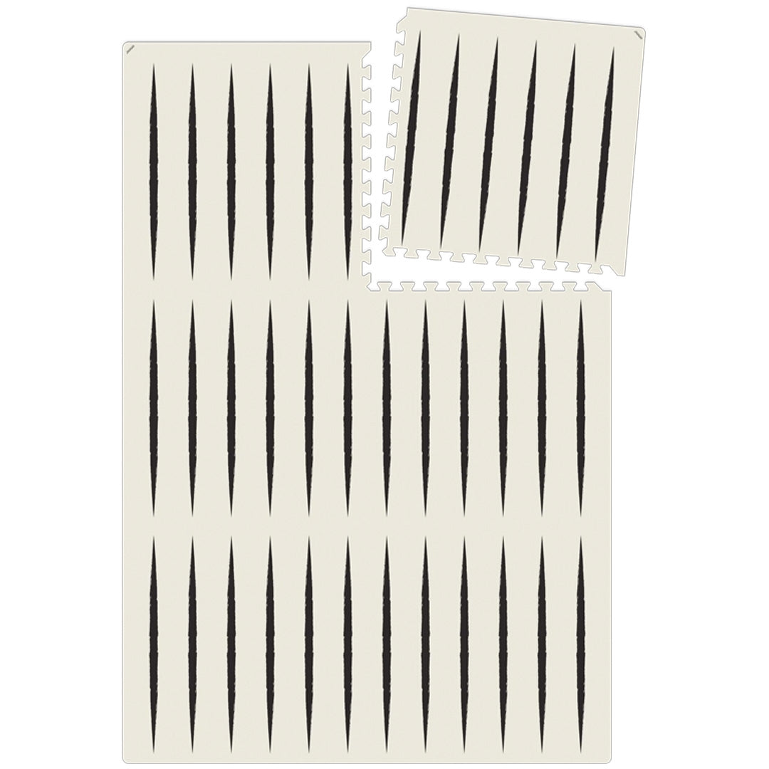 eeveve foam speelmat met ecru en zwart geometrisch patroon, van bovenaf gezien met een losse tegel.