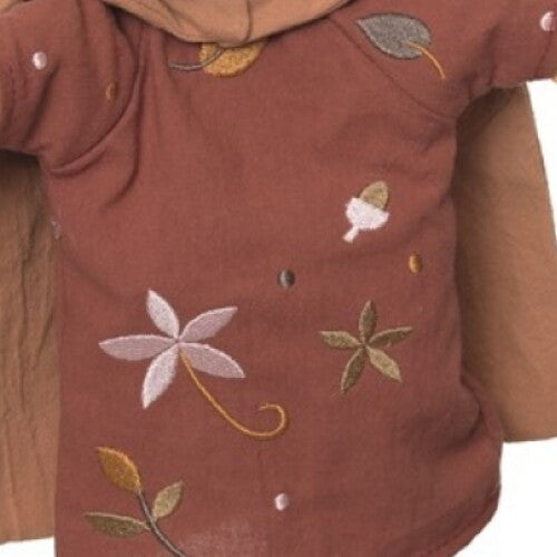 Detail van de bruine kleding van de handpop met geborduurde bladeren, bloemen en eikels.