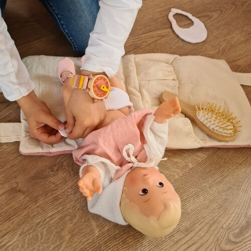 Kind verschoont een pop op de Egmont Toys poppenverschoonmat.