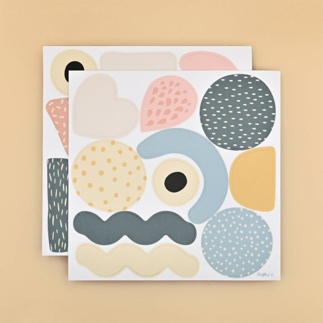 Twee vellen met kleurrijke abstracte magnetische vormen.