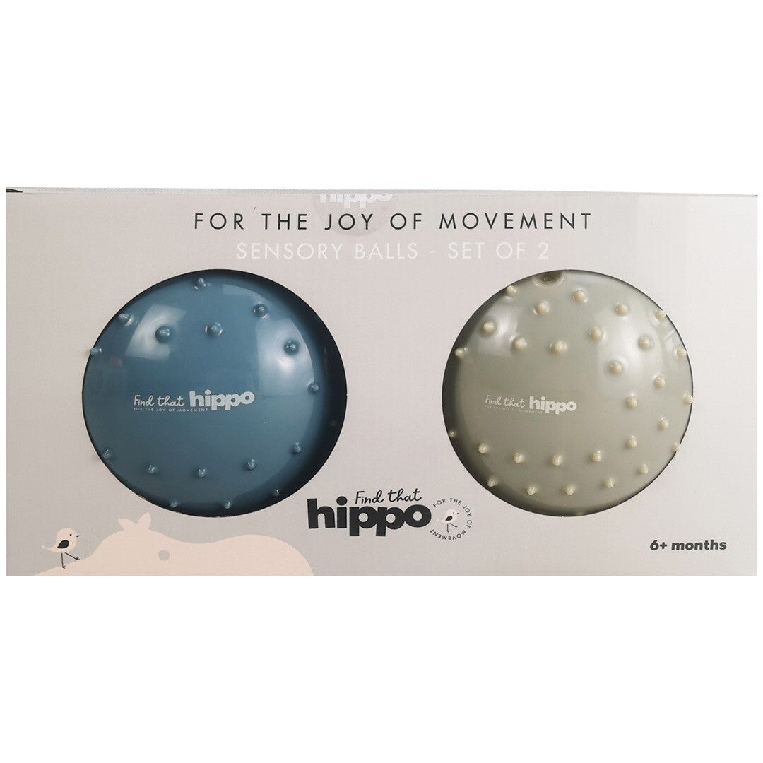 De verpakking van de find that hippo set met twee sensorische ballen, één blauw en één crème.
