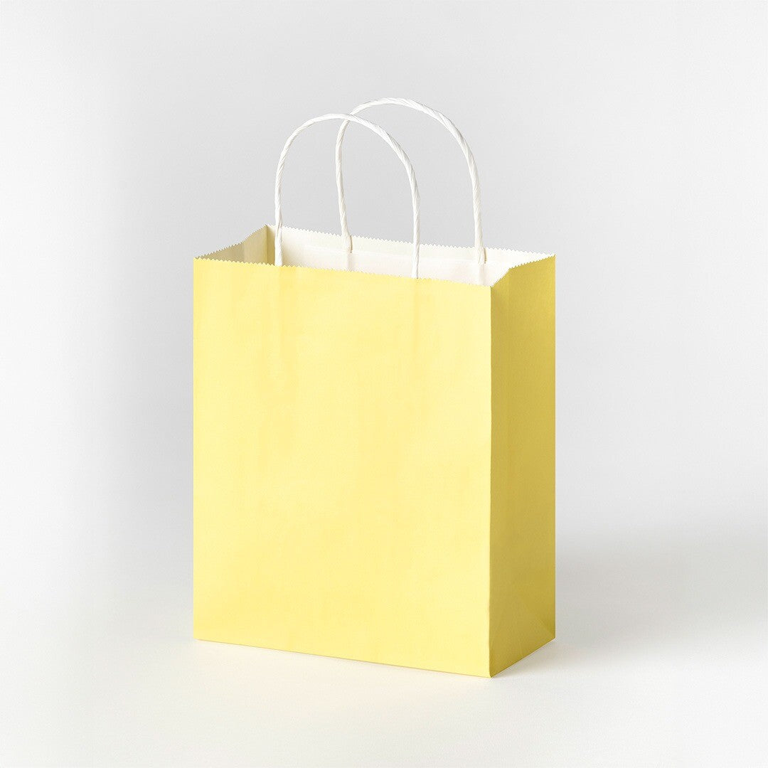 Een geel Folia papieren cadeauzakje met witte handvatten.