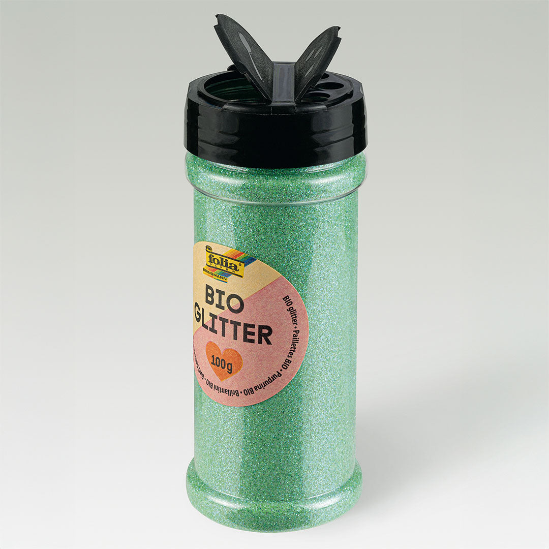 folia mintgroene losse glitters in een open shakerfles, schuin van bovenaf gefotografeerd.