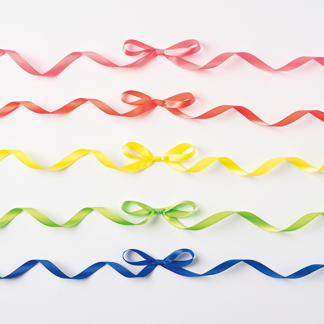 Vijf neon satijnen linten in roze, oranje, geel, groen en blauw, elk met een strik, op een witte achtergrond.