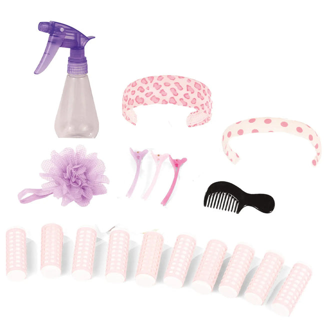 Götz poppen haarstylingset met diverse roze en paarse haaraccessoires zoals rollers, haarbanden, clips, een kam, spuitfles en badspons.
