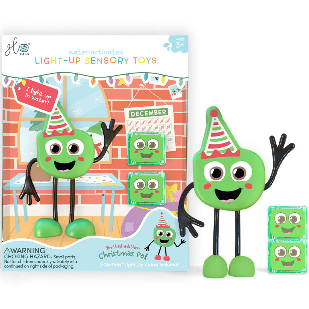 Glo Pals kerst badspeelgoed, een groen figuurtje met feestmuts en de productverpakking ernaast.