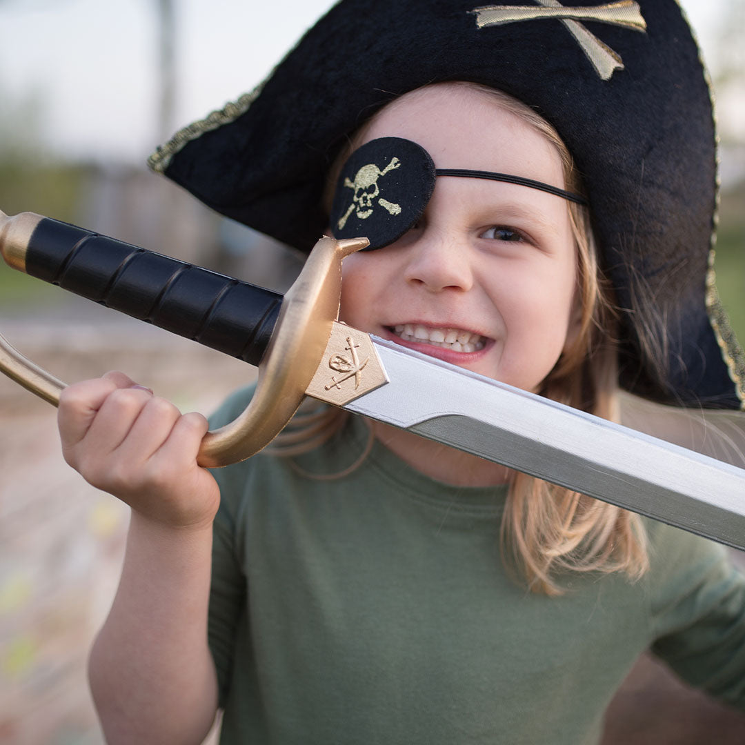 Lachend kind met Great Pretenders piraten ooglapje en hoed, zwaaiend met een speelgoedzwaard.