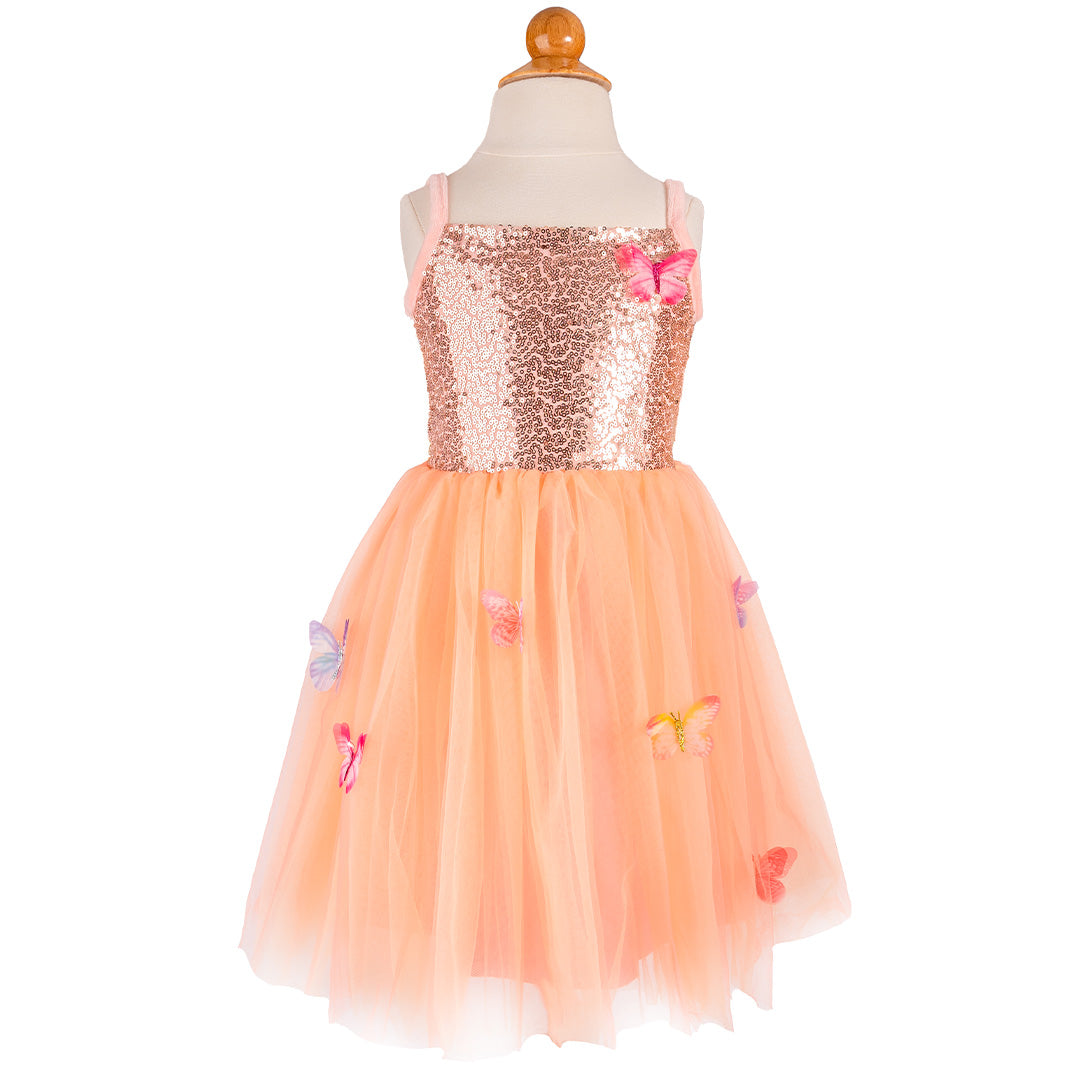 Great pretenders verkleedjurk met perzikkleurige pailletten top en tule rok met vlinders, gepresenteerd op een paspop.