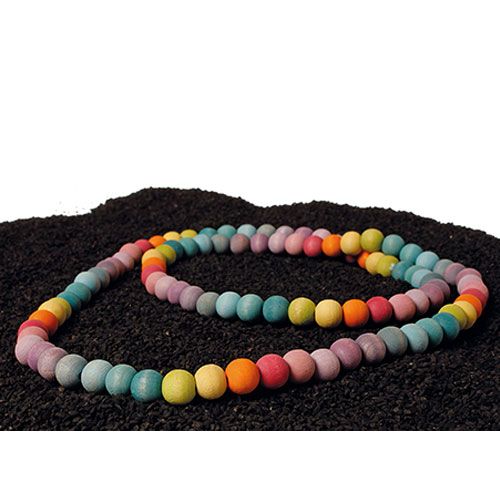 Een lange ketting van grimm's houten pastel kralen in een regenboog van kleuren op een zwarte ondergrond.