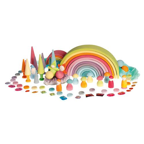 Een uitgebreide grimm's speelset met een regenboog, houten figuren en veelkleurige speelgoed diamanten.