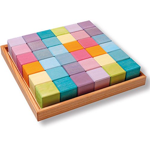 Grimm's houten mozaïekblokjes in pastelkleuren, netjes gerangschikt in een houten bakje.