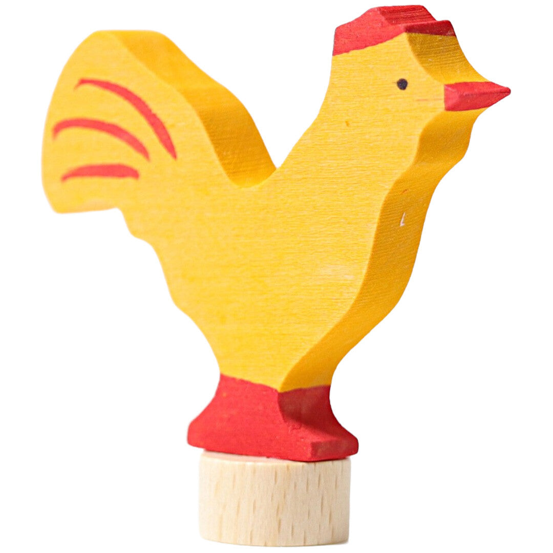grimm's houten decoratiefiguur van een gele haan, schuin van voren gefotografeerd.