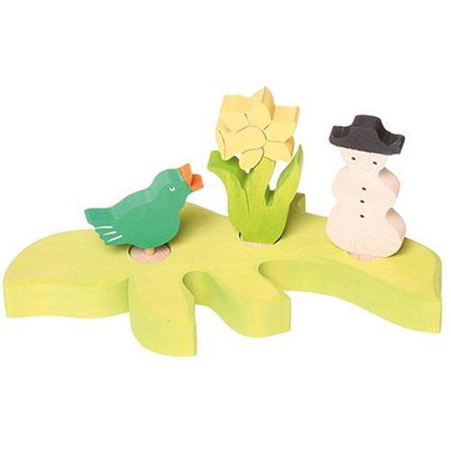 grimm's lichtgroene houten decoratietak met een vogel, gele bloem en sneeuwpop.