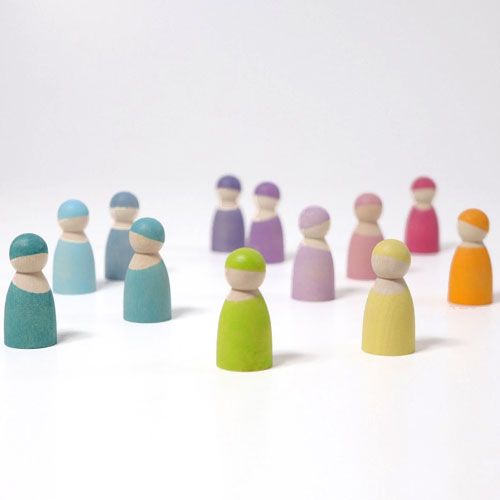 Twaalf grimm's houten popjes in pastelkleuren staan verspreid op een witte ondergrond.