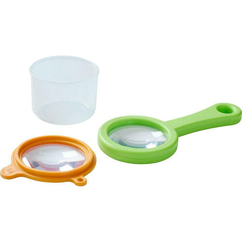 De Haba bekerloep, bestaande uit een doorzichtige beker, oranje loepdeksel en groene loephandgreep, los van elkaar.