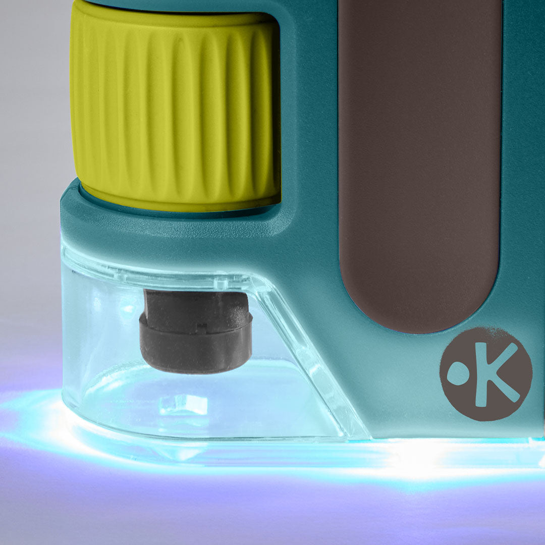 Detailopname van de onderkant van de Haba Terra Kids zakmicroscoop met het blauwe licht aan.