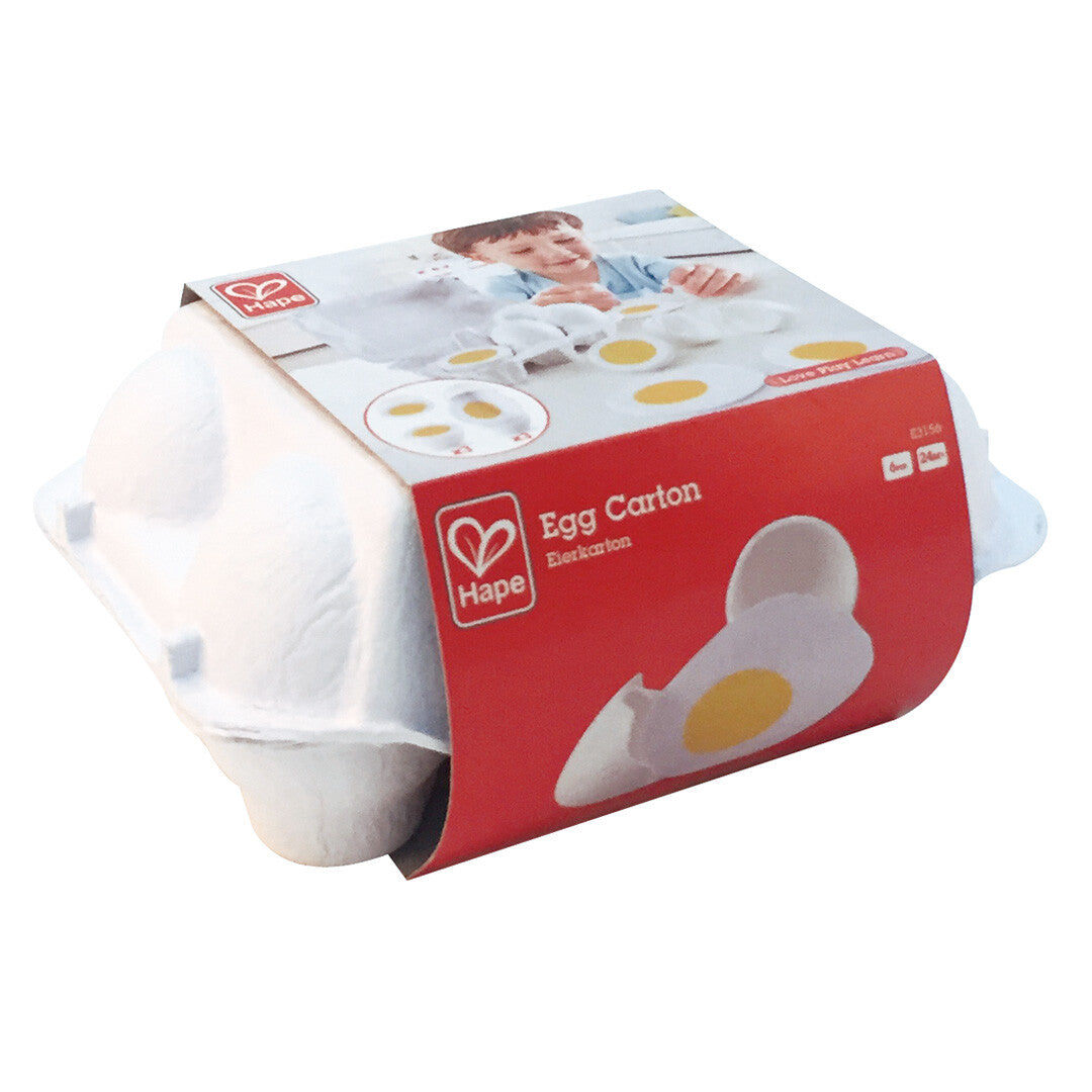 De verpakking van de Hape speelgoed eieren, een wit kartonnen doosje met een rode band.