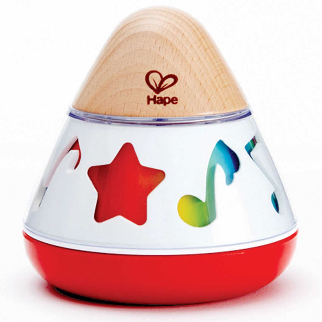 Hape muziekspeelgoed met houten top, witte zijkant met ster- en muzieknootuitsparingen en rode basis.