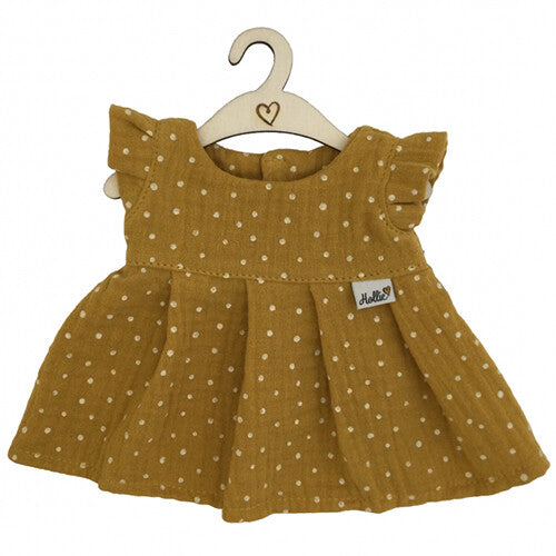 Hollie poppenkleding jurkje, okergeel met witte stippen, hangend aan een houten hanger.