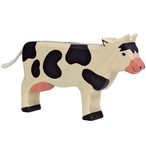 Holztiger houten dierenfiguurtje van een staande zwart-witte koe.