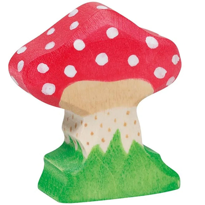 Holztiger houten speelgoedfiguur van een rode vliegenzwam met witte stippen op een groene ondergrond.