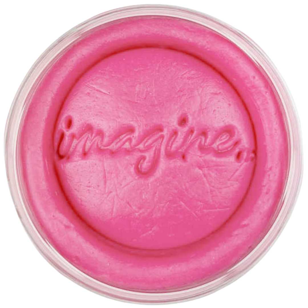 Roze invitation to imagine speelklei in een potje met de tekst 'imagine' erin gedrukt.