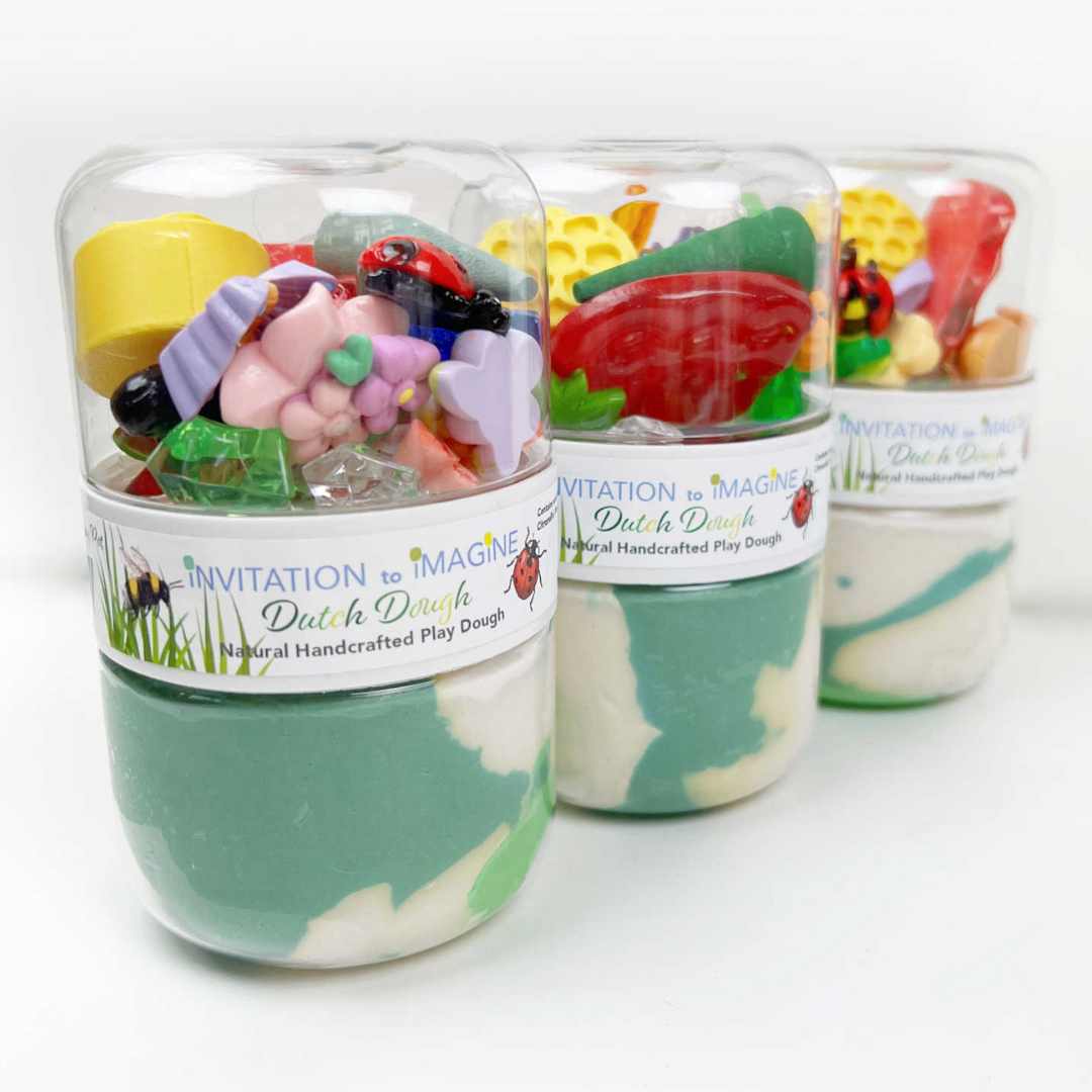 Drie invitation to imagine speelklei play pots met groene en witte klei en diverse tuin-thema accessoires.