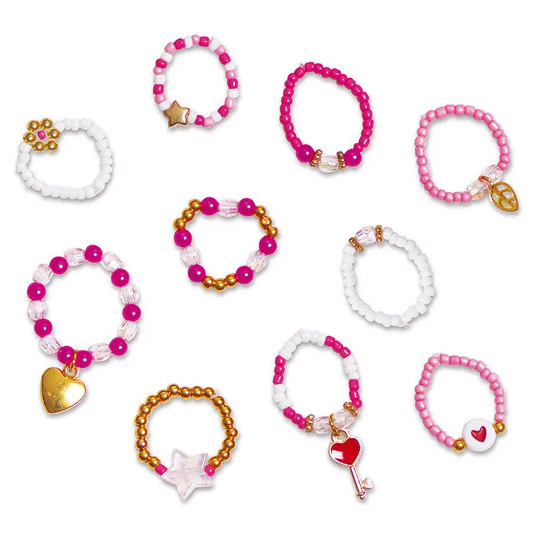 Tien verschillende roze, witte en gouden parelringen met hartjes en sterren.