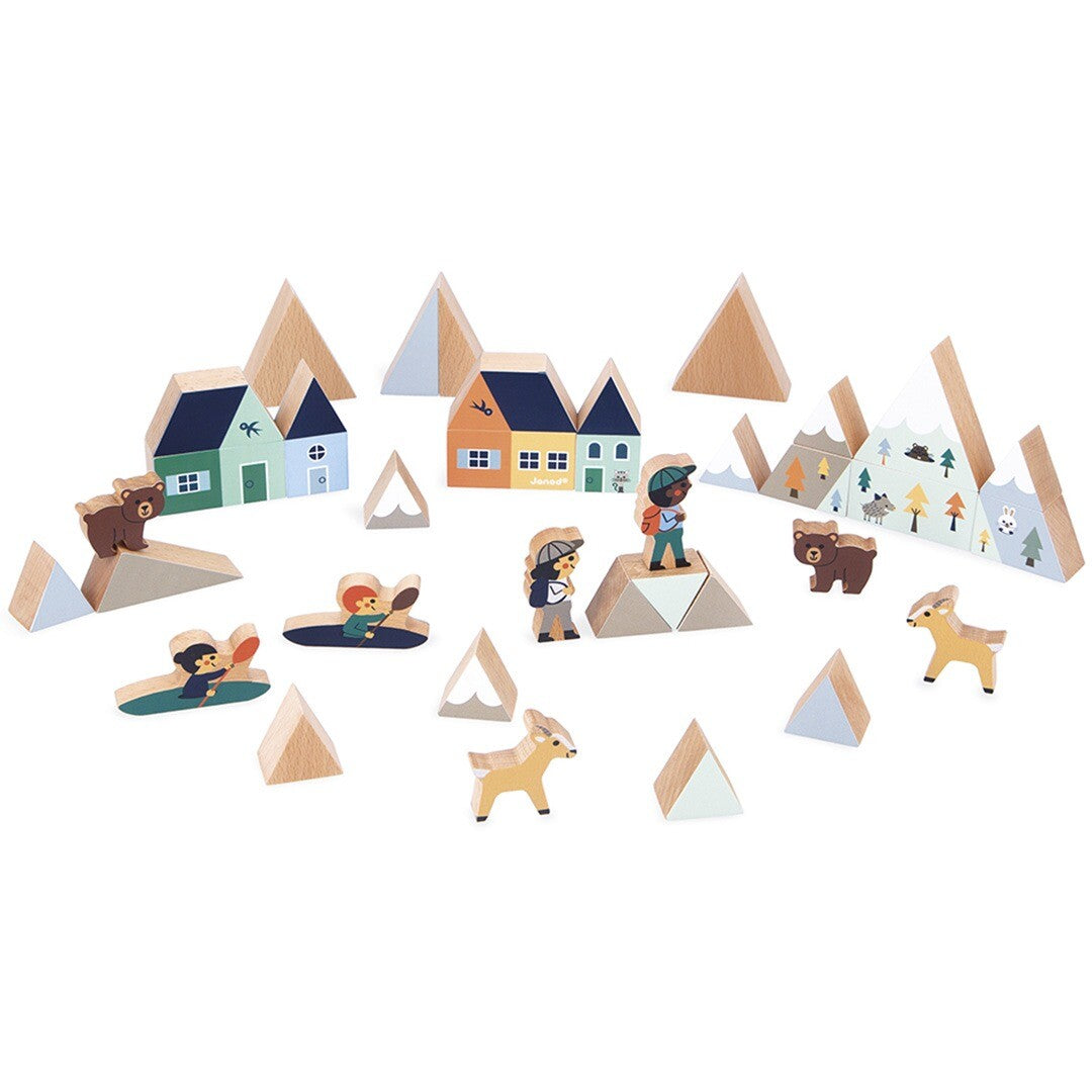 Janod houten blokkenset bergvallei met huizen, bergen, mensen en dierenfiguren uitgestald.