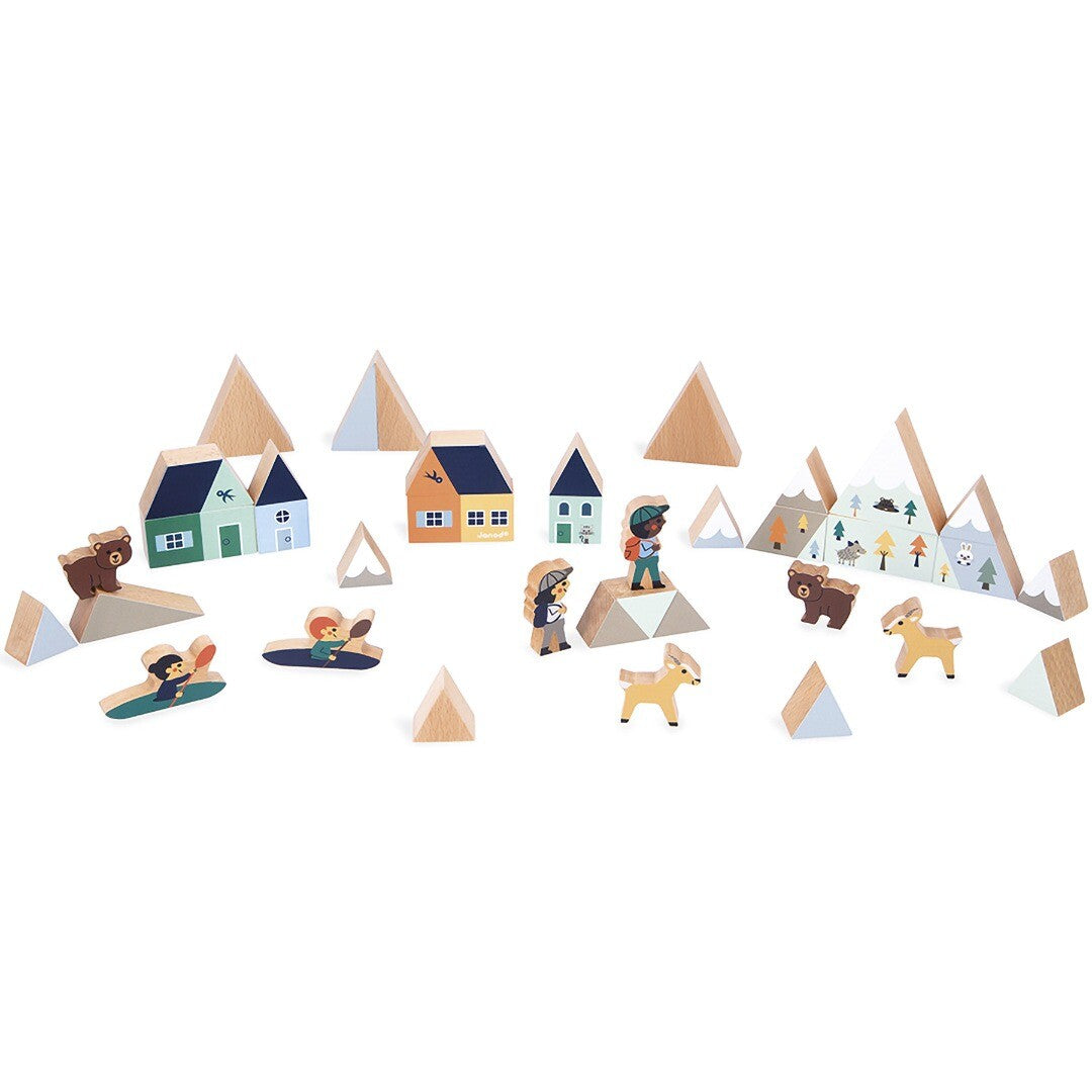 Janod houten blokkenset bergvallei met huizen, bergen, mensen en dierenfiguren uitgestald.