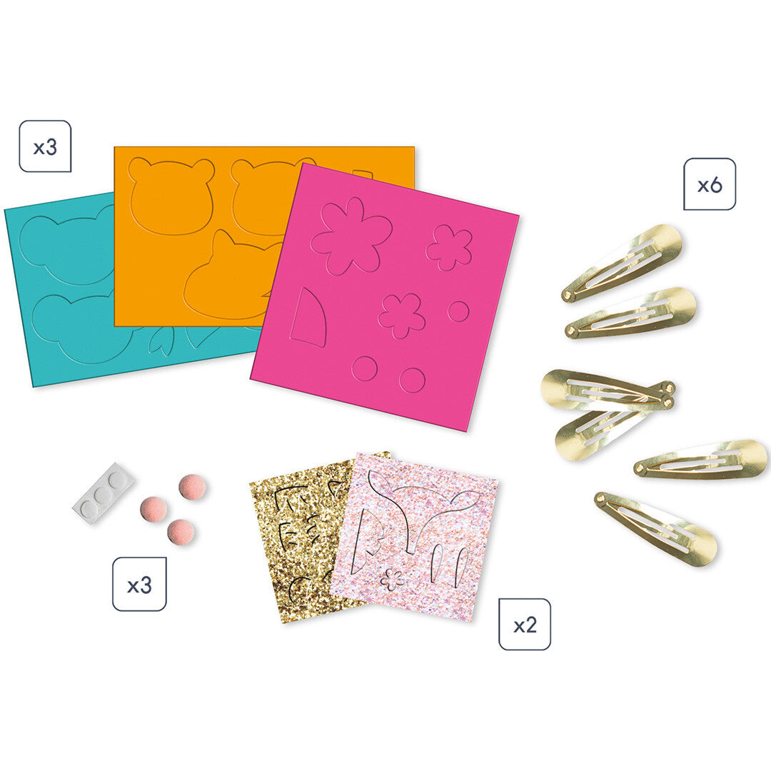 Overzicht van de onderdelen van de knutselset, inclusief voorgesneden vilt, glittervellen en zes haarclips.