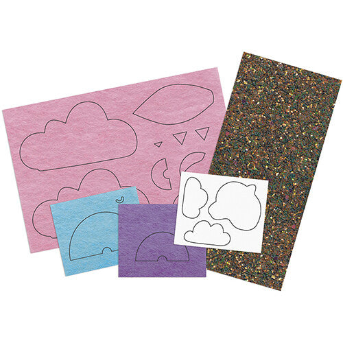 Diverse vellen vilt en glittermateriaal met uitgesneden vormen voor wolken en regenbogen.