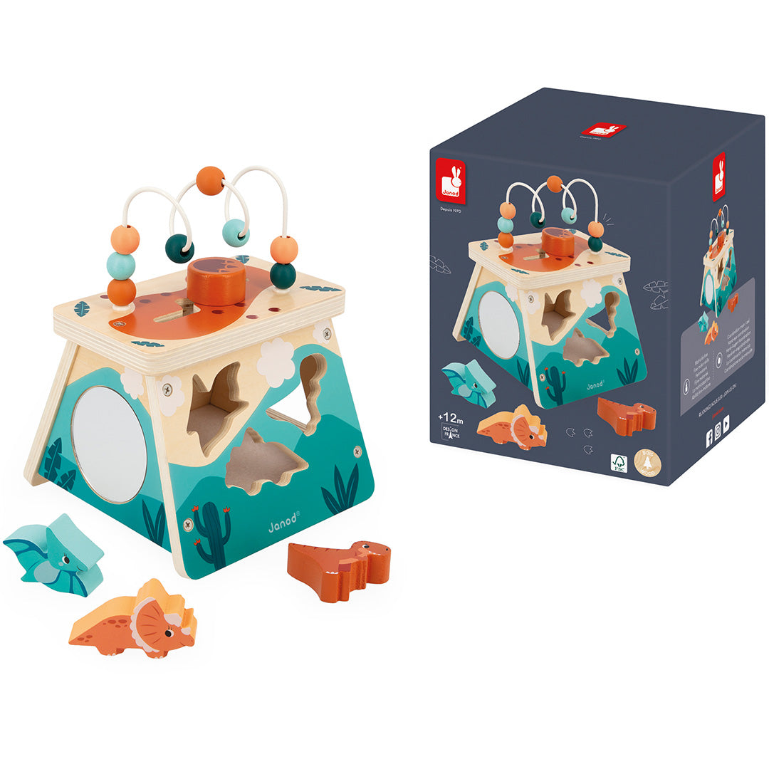 Het Janod houten activiteitscentrum met dinosaurus thema staat naast de donkerblauwe productverpakking.