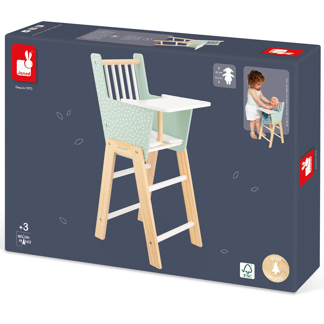 De verpakking van de Janod poppenstoel met een afbeelding van het product en een spelend kind.