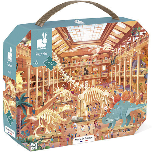 Janod legpuzzel van 100 stukjes met een natuurhistorisch museum vol dinosaurussen, getoond in de verpakking.