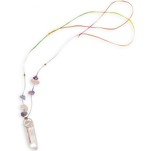 Detail van een ketting met een heldere kristallen hanger, kleine roze en paarse steentjes en gouden kraaltjes aan een kleurrijk koord.