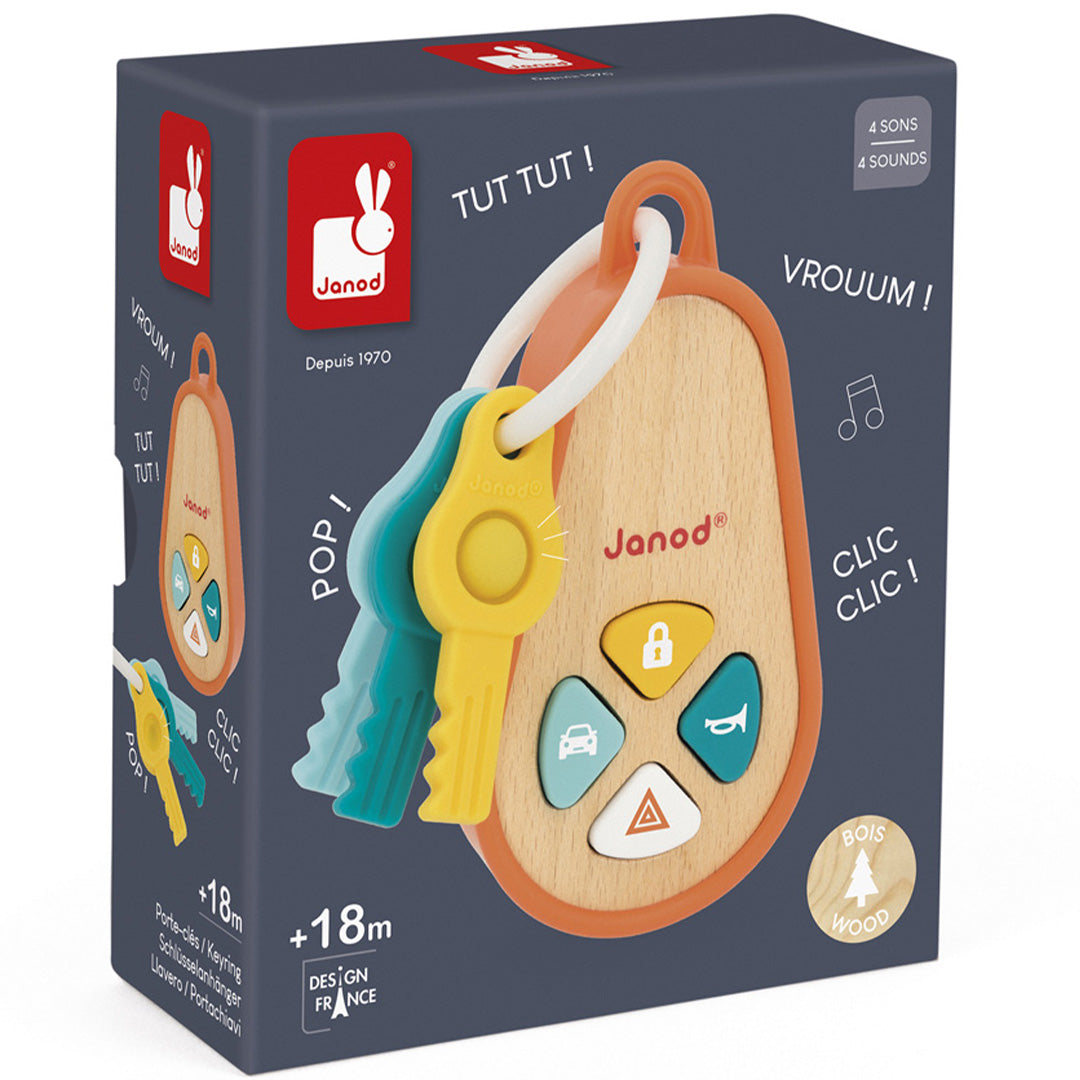 De verpakking van het Janod houten activiteitenspeeltje sleutelhanger met geluid, met productafbeelding en kenmerken.