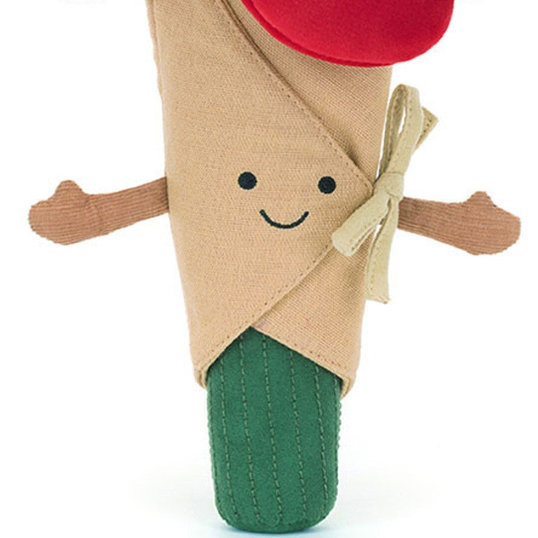 Detail van het Jellycat knuffelboeket met het lachende gezichtje en de beige wikkel.
