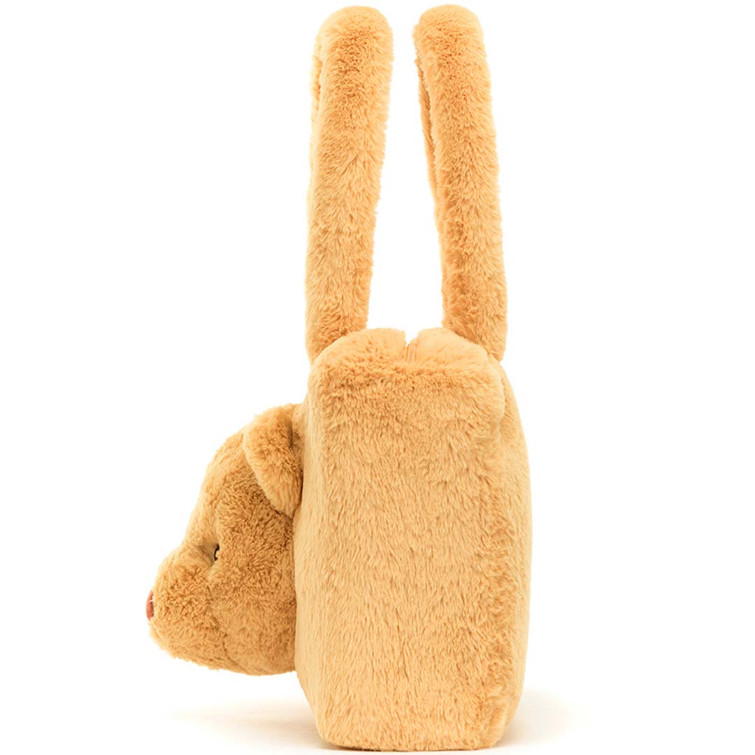 Zijaanzicht van de beige pluche handtas met berenkop.