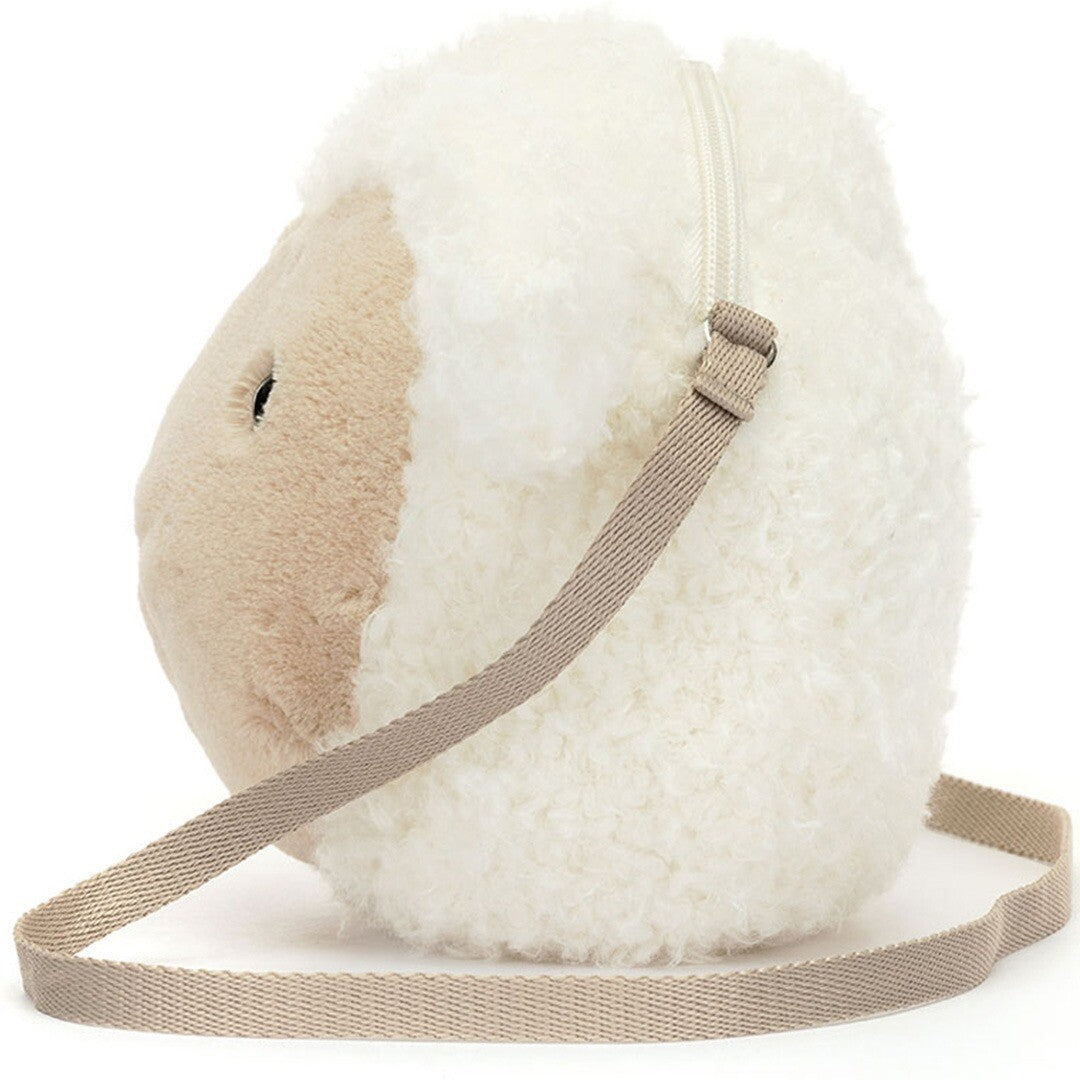 Zijaanzicht van de Jellycat pluchen lam kindertas met de schouderband.