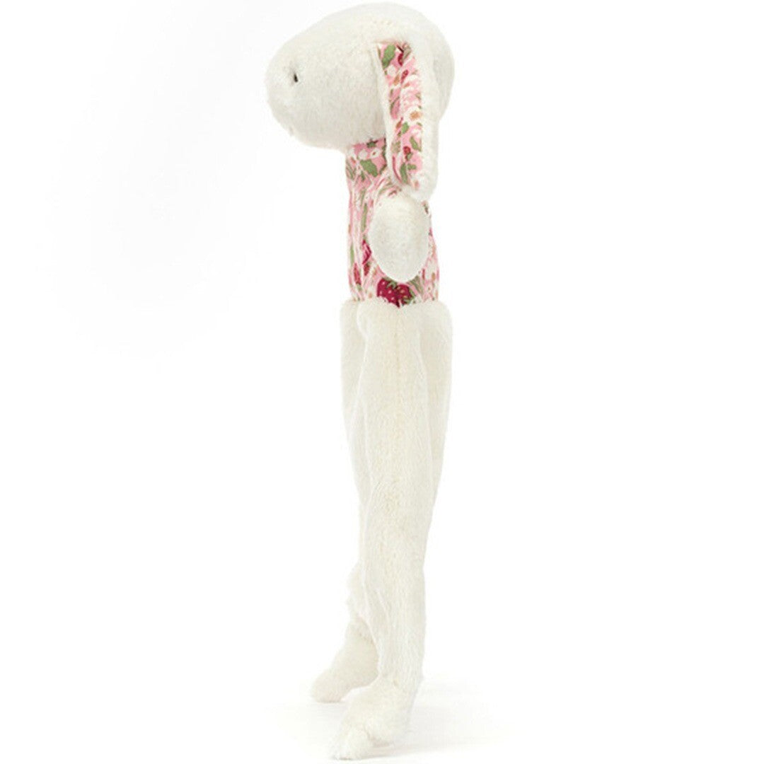 Jellycat knuffeldoek in de vorm van een wit konijn met roze aardbeienpatroon, van de zijkant gezien.