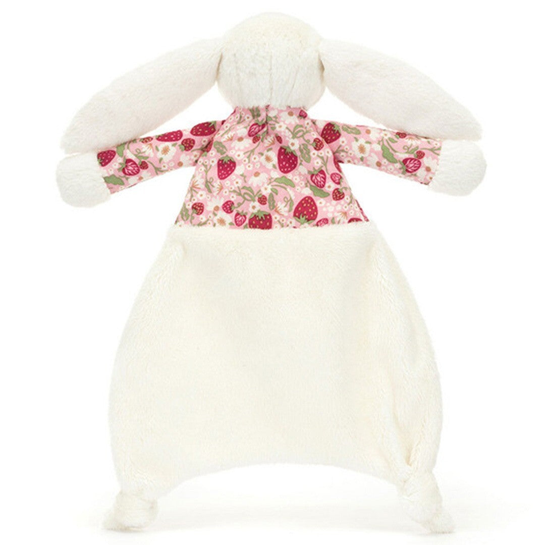 Jellycat knuffeldoek in de vorm van een wit konijn met een roze lijfje met aardbeienpatroon, van achteren gezien.