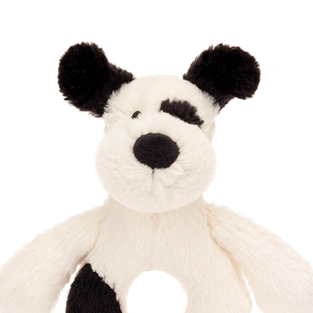 Detailopname van de kop van de Jellycat puppy rammelaar, recht van voren.