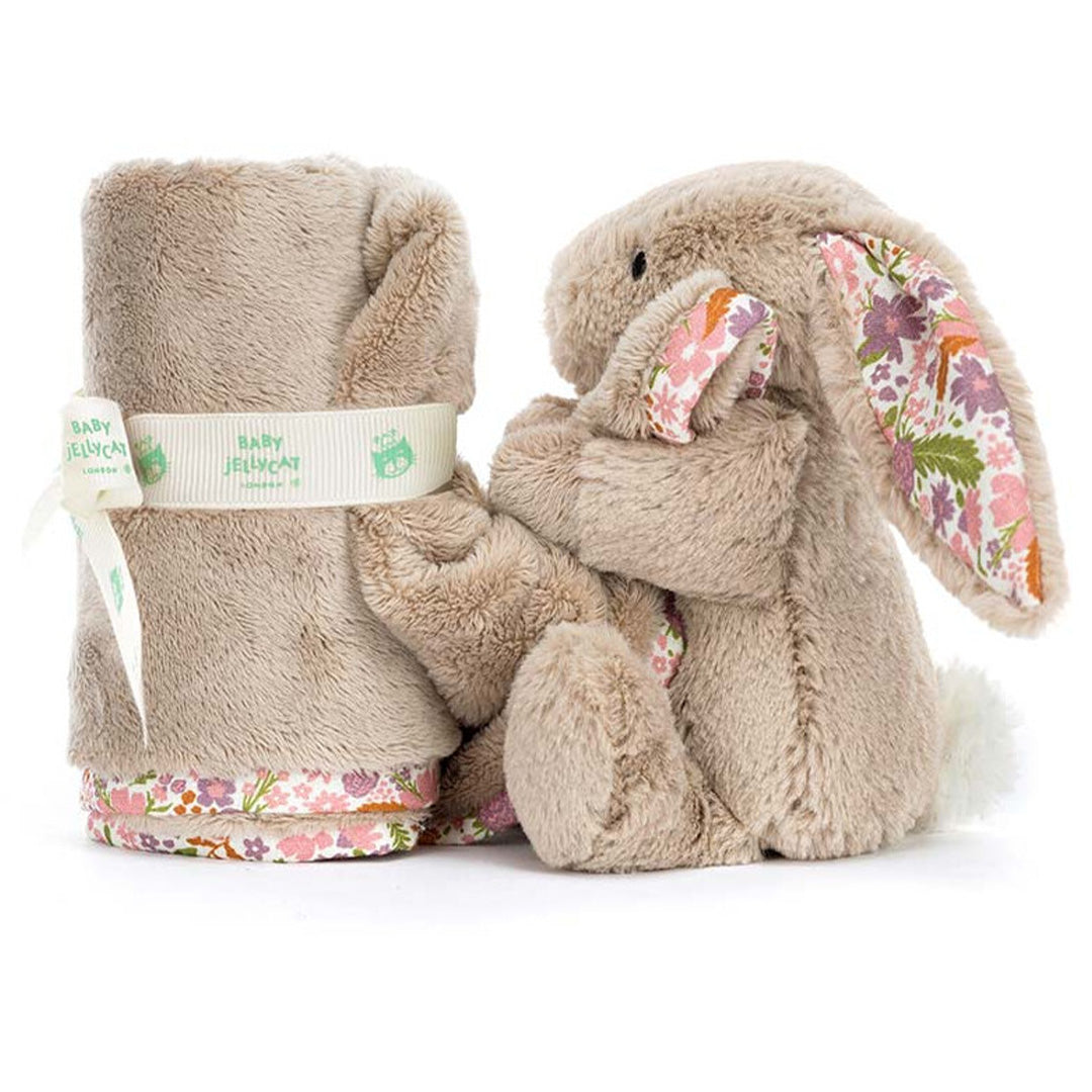Jellycat beige konijnen knuffeldoek opgerold met lint, naast de pluchen konijnenrug met gebloemde oren.