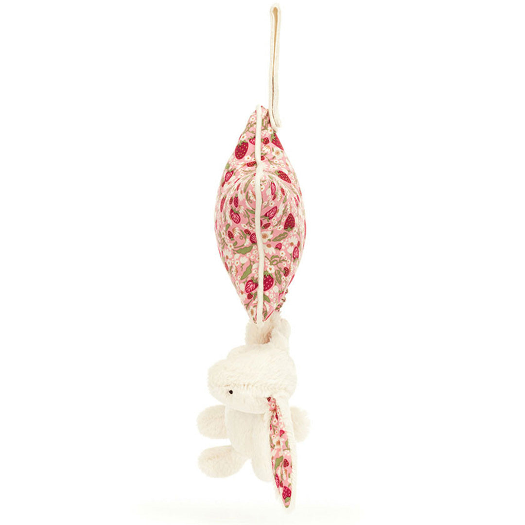 Zijaanzicht van het Jellycat babyspeelgoed muziekdoosje met de roze ster en het pluche konijn.
