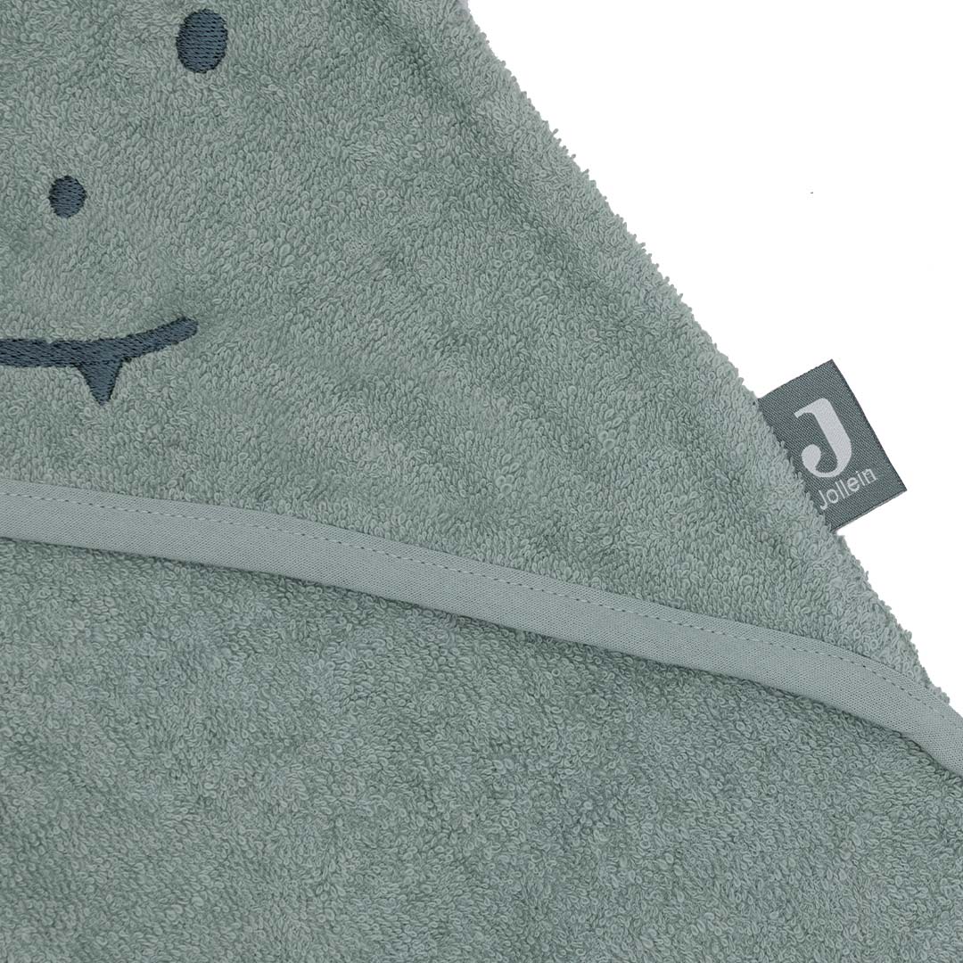 Detail van de Jollein baby badcape met het merklabel en een deel van het geborduurde krokodillenhoofdje.
