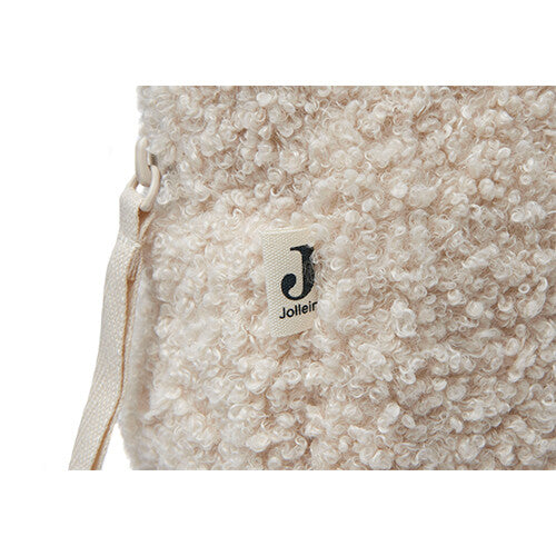Detail van de bouclé textuur en het Jollein merklabel aan de zijkant van de toilettas.