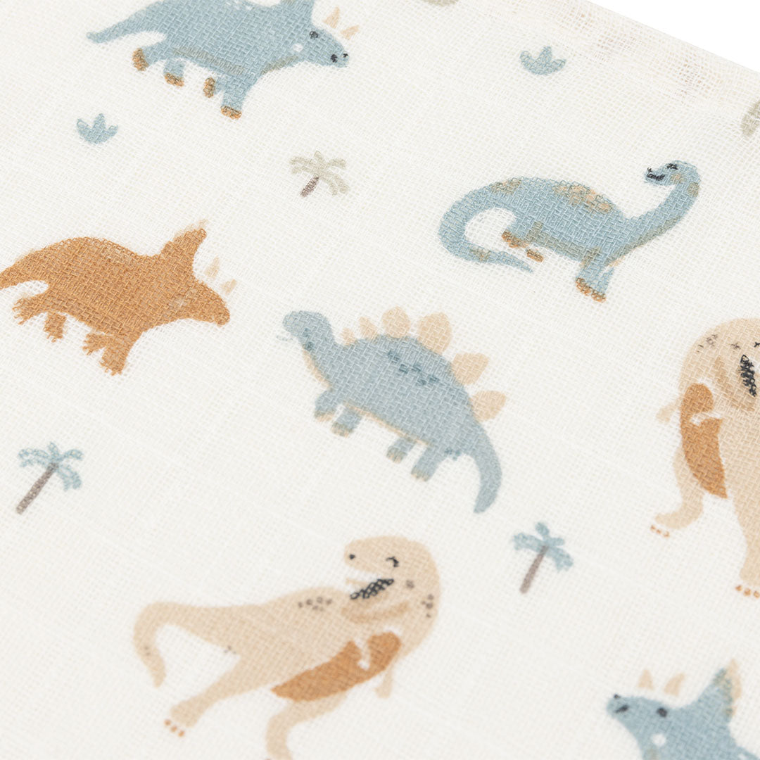 Detail van de stof van een Jollein hydrofiele multidoek met illustraties van verschillende dinosaurussen.