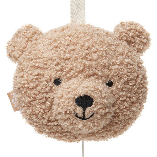 Close-up van het pluizige beige teddybeerhoofd van het Jollein muziekdoosje.